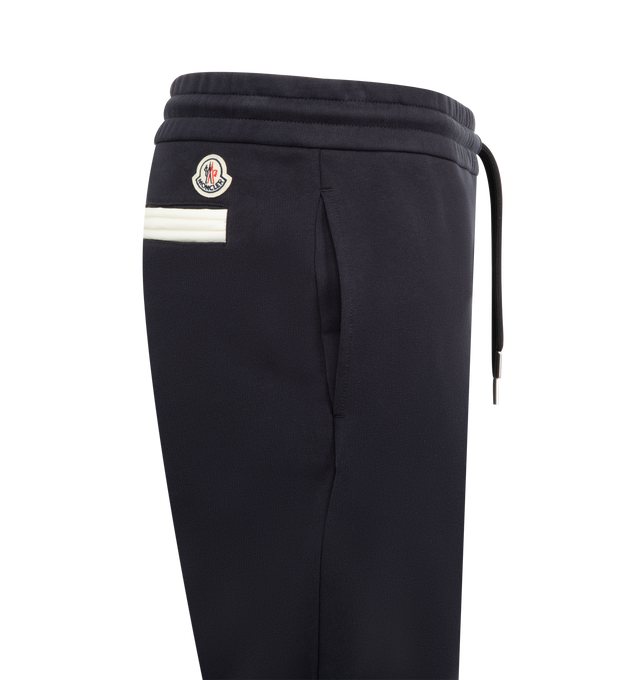 Image 4 of 4 - NAVY - MONCLER Sweatpants featuring elastic waistband with drawstring fastening, side slit pockets, back welt pocket, elastic hem, logo on back and front leg. Cotton.