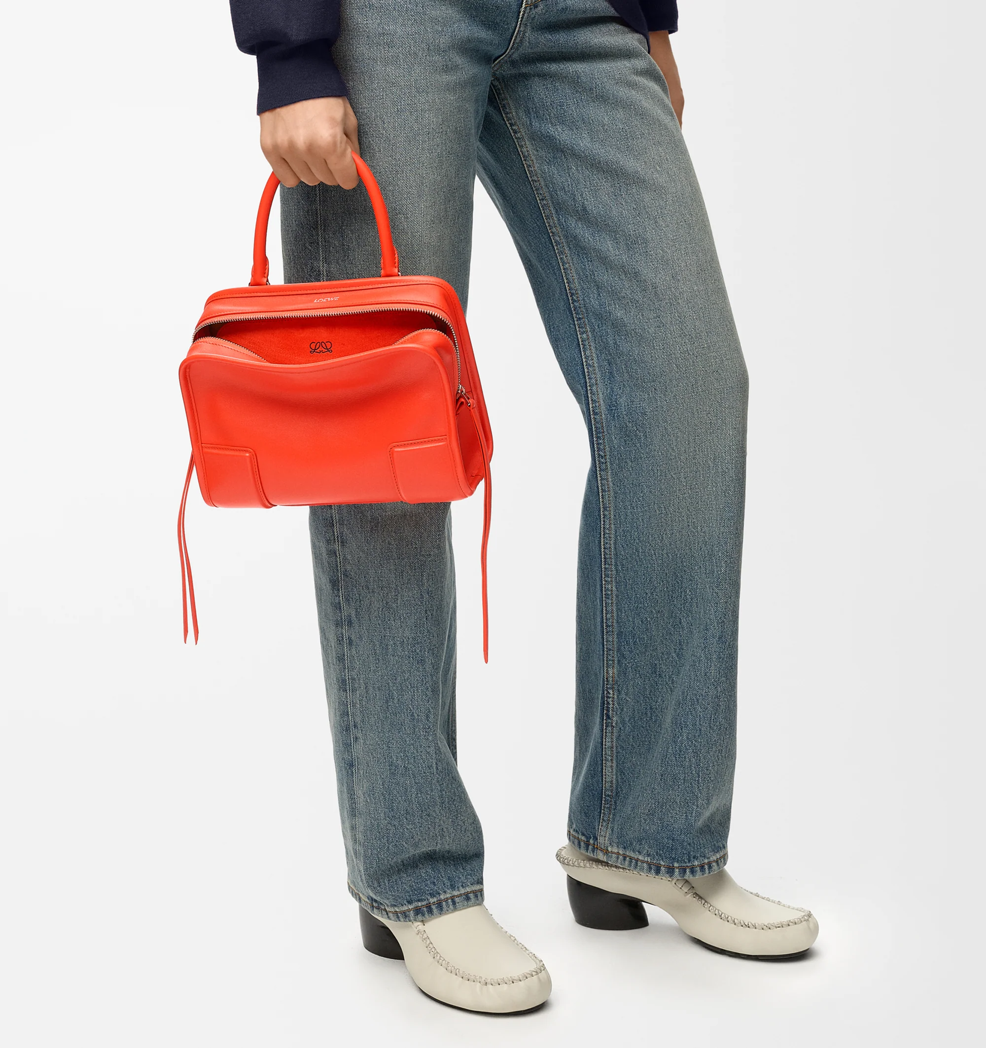 Image 3 of 17 - ORANGE - Loewe Small Amazona 180 Bag in leather features a relaxed silhouette anchored by a single toron top handle, designed to be carried open, while a concealed closure secures the main compartment, three carry options: short handle, removable shoulder strap and crossbody, zip closure with two leather zip pullers, two compartments, main compartment closed with magnetic closure, internal flat pocket, left side d-ring for customization, nappa lambskin lining, and embossed double L branding.