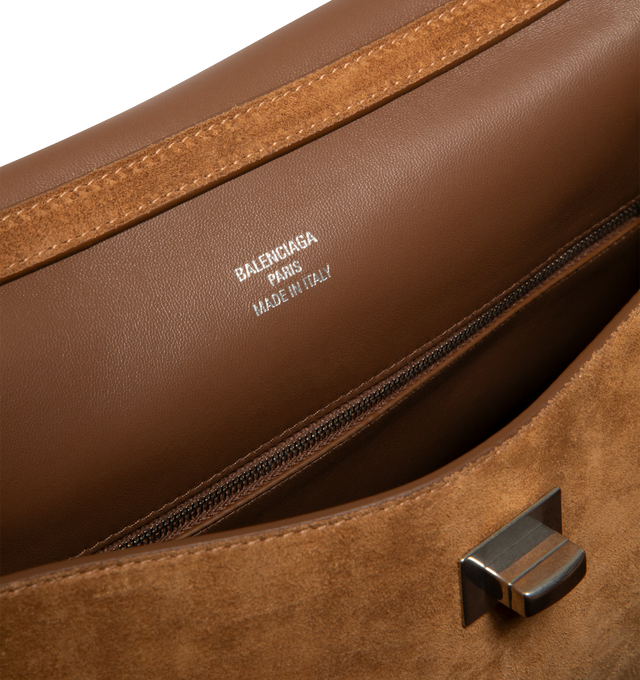 Image 4 of 4 - BROWN - BALENCIAGA Rodeo Handbag Medium in waxed suede calfskin and smooth calfskin featuring one handle, removable shoulder strap, removable cloche cls with two split rings, aged-silver hardware, turn lock closure, wide front pocket, 1 main compartment, 1 inner zipped pocket, 2 flat pockets at back, side snaps, 4 brass feet and nappa lambskin lining. L13.8 x H9.2 x W4.3 inch. Calfskin. Made in Italy.