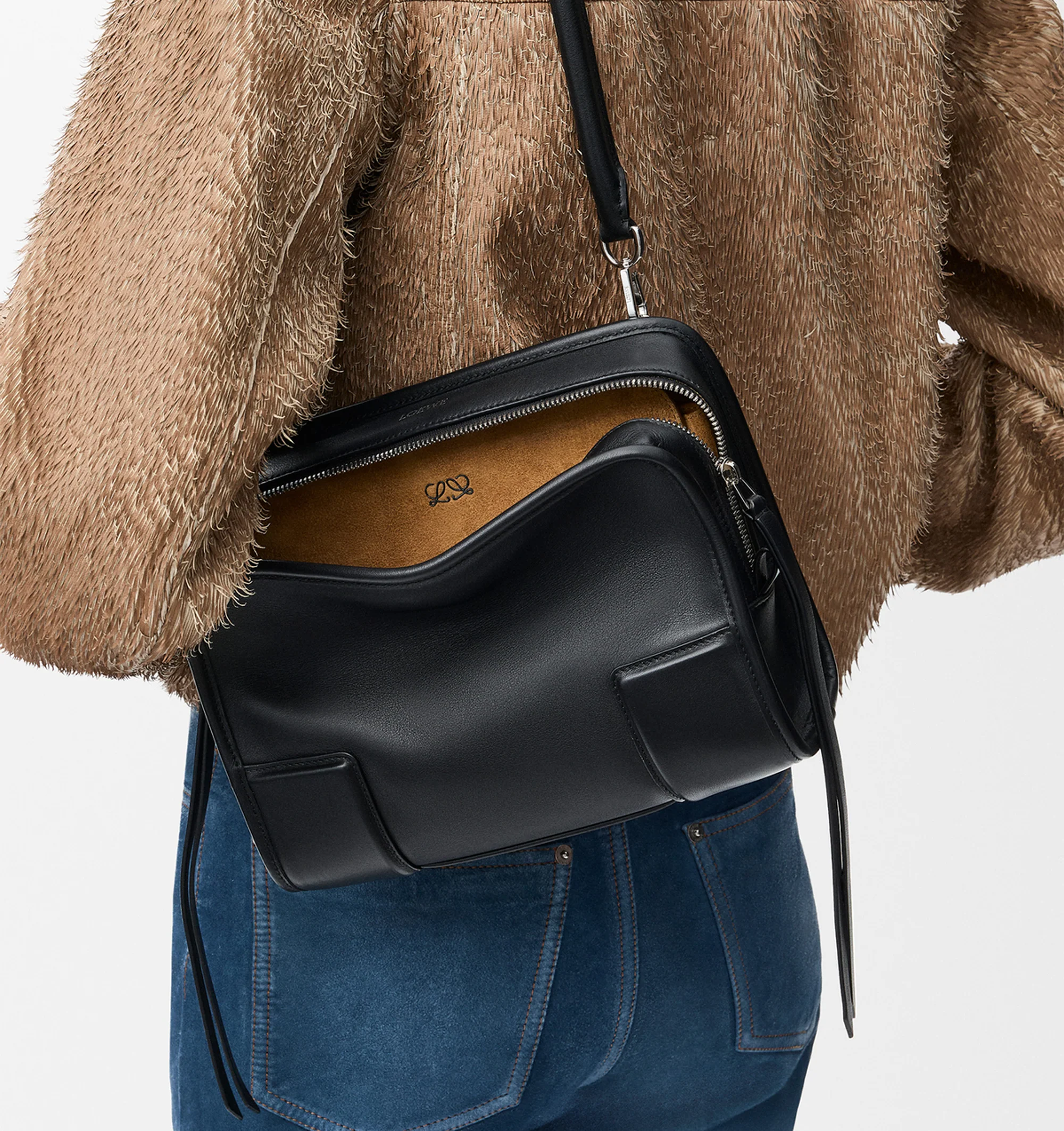 Image 3 of 16 - BLACK - Loewe Small Amazona 180 Bag in leather features a relaxed silhouette anchored by a single toron top handle, designed to be carried open, while a concealed closure secures the main compartment, three carry options: short handle, removable shoulder strap and crossbody, zip closure with two leather zip pullers, two compartments, main compartment closed with magnetic closure, internal flat pocket, left side d-ring for customization, nappa lambskin lining, and embossed double L branding.