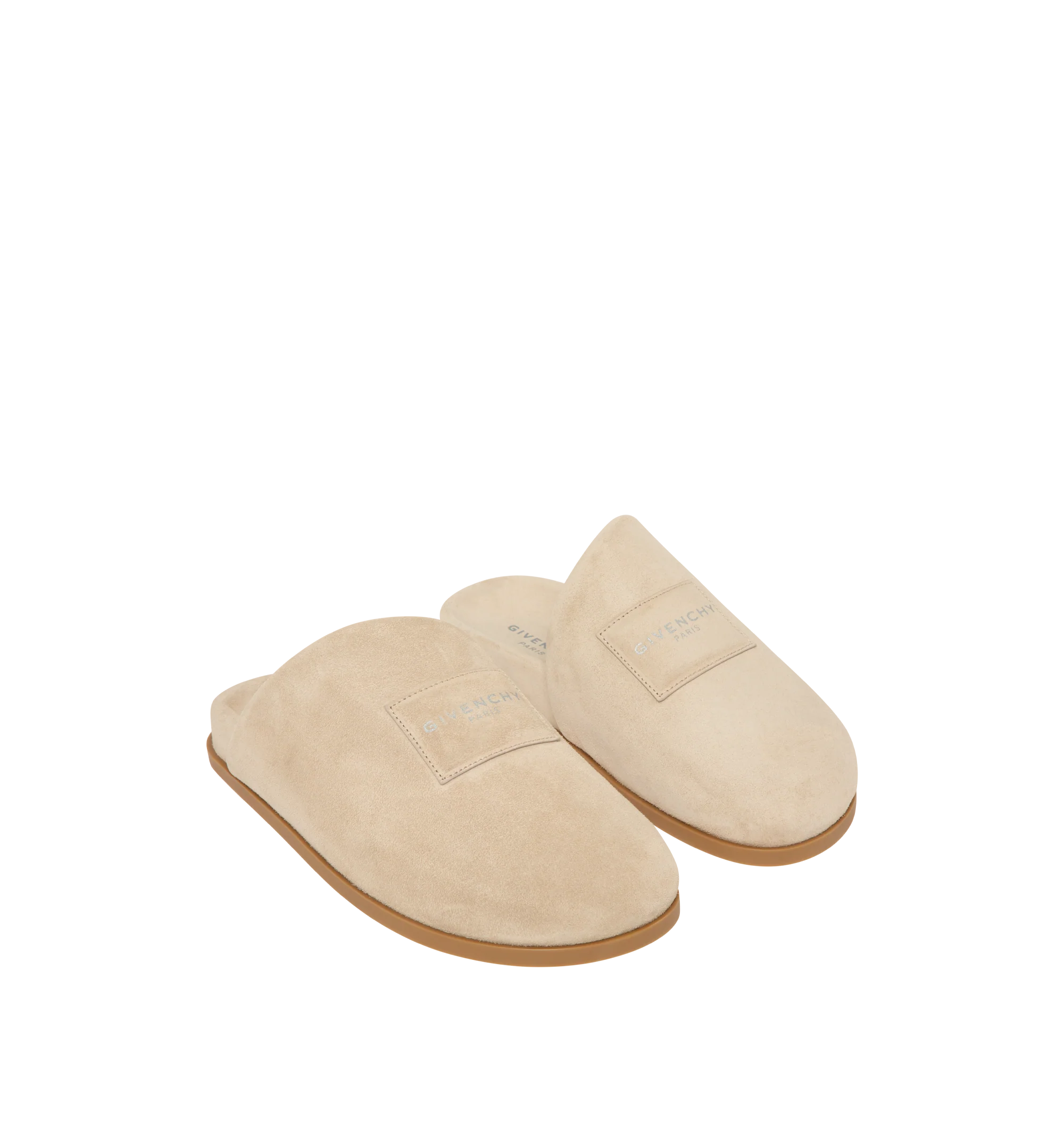 Image 2 of 5 - NEUTRAL - Givenchy Puffy Mules in Suede are crafted from supple calfskin suede and feature the house's signature Puffy silhouette with an asymmetric, slip-on design. Designed with a tonal padded label accented by a silvery Givenchy Paris logo, a branded leather insole, and a raised Givenchy signature beneath the sole, the mules combine comfort with a refined contemporary aesthetic. Main Material: 100% Calfskin Leather. Lining: 100% Calfskin Leather. Made in Italy.