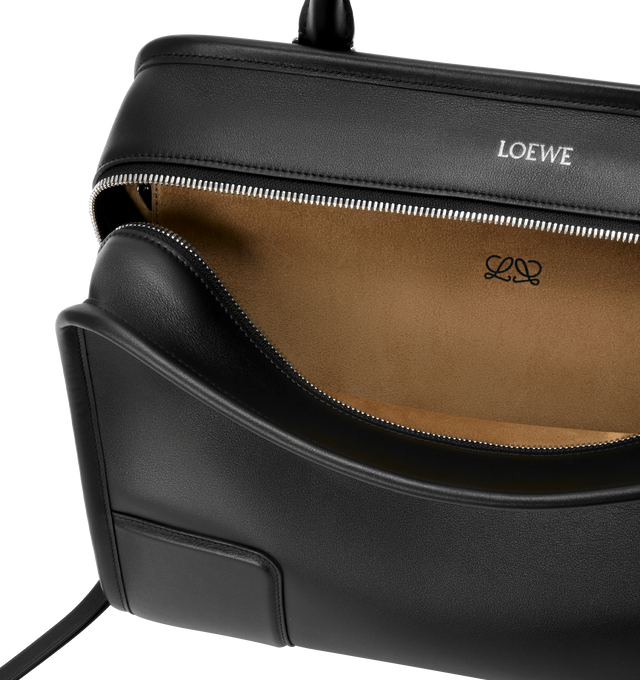 Image 8 of 16 - BLACK - Loewe Amazona 180 large bag takes on a relaxed silhouette anchored by a single toron top handle. It is designed to be carried open, while a concealed closure secures the main compartment. Removable shoulder and crossbody straps make it highly versatile. This large version is crafted in soft calfskin. Three carry options: short handle, removable shoulder strap and crossbody. Features zip closure with two leather zip pullers, two compartments, main compartment closed with magnetic clos