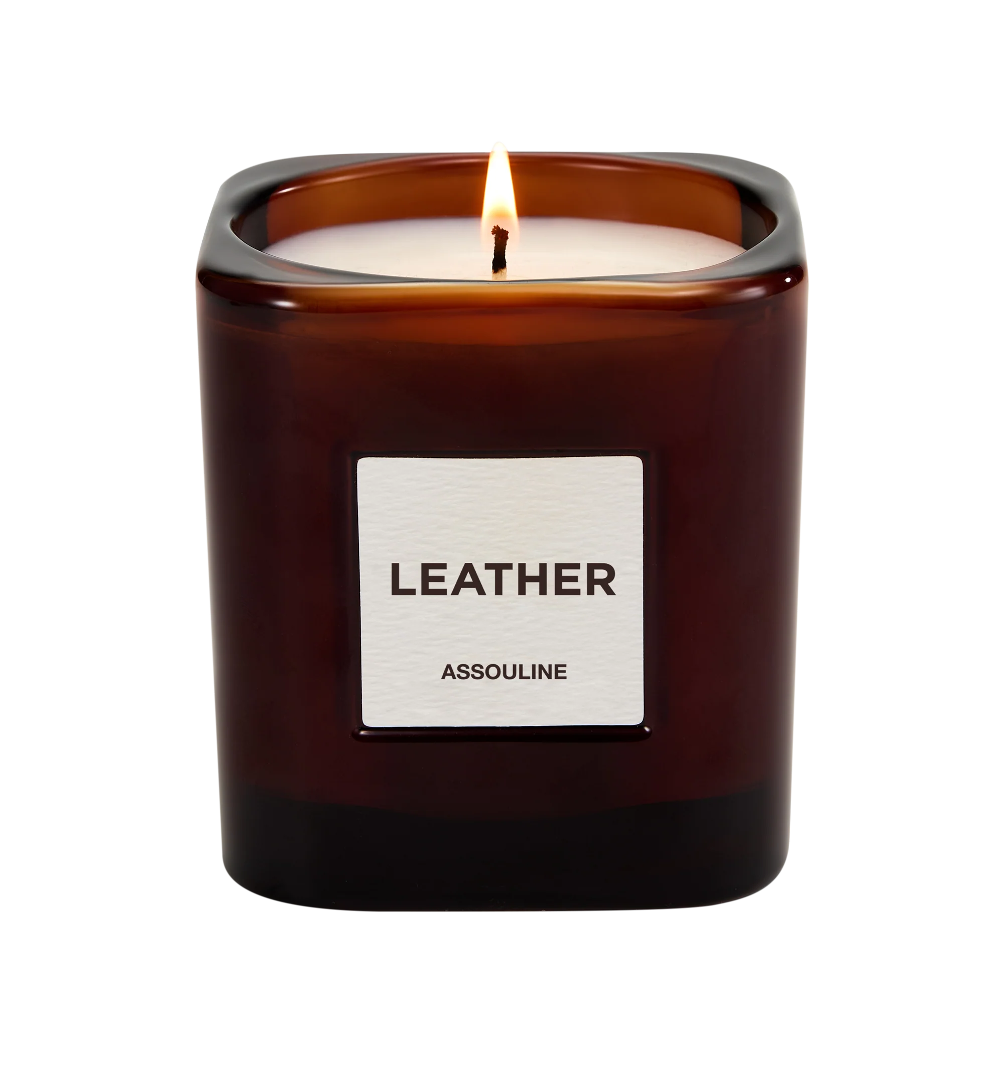 Image 2 of 3 - RED - Assouline Library Candle Leather is a luxury scented candle that captures the warm, sophisticated ambiance of leather-bound books and refined interiors with a rich fragrance blending leather, clove, tobacco, freesia, orris, and vetiver. Housed in a heavyweight amber glass vessel with a textured paper label, this designer candle is crafted from a premium soy, coconut, and paraffin wax blend for a clean, even burn and exceptional scent throw. Top Notes: Leather, Clove. Heart Notes: Tobac