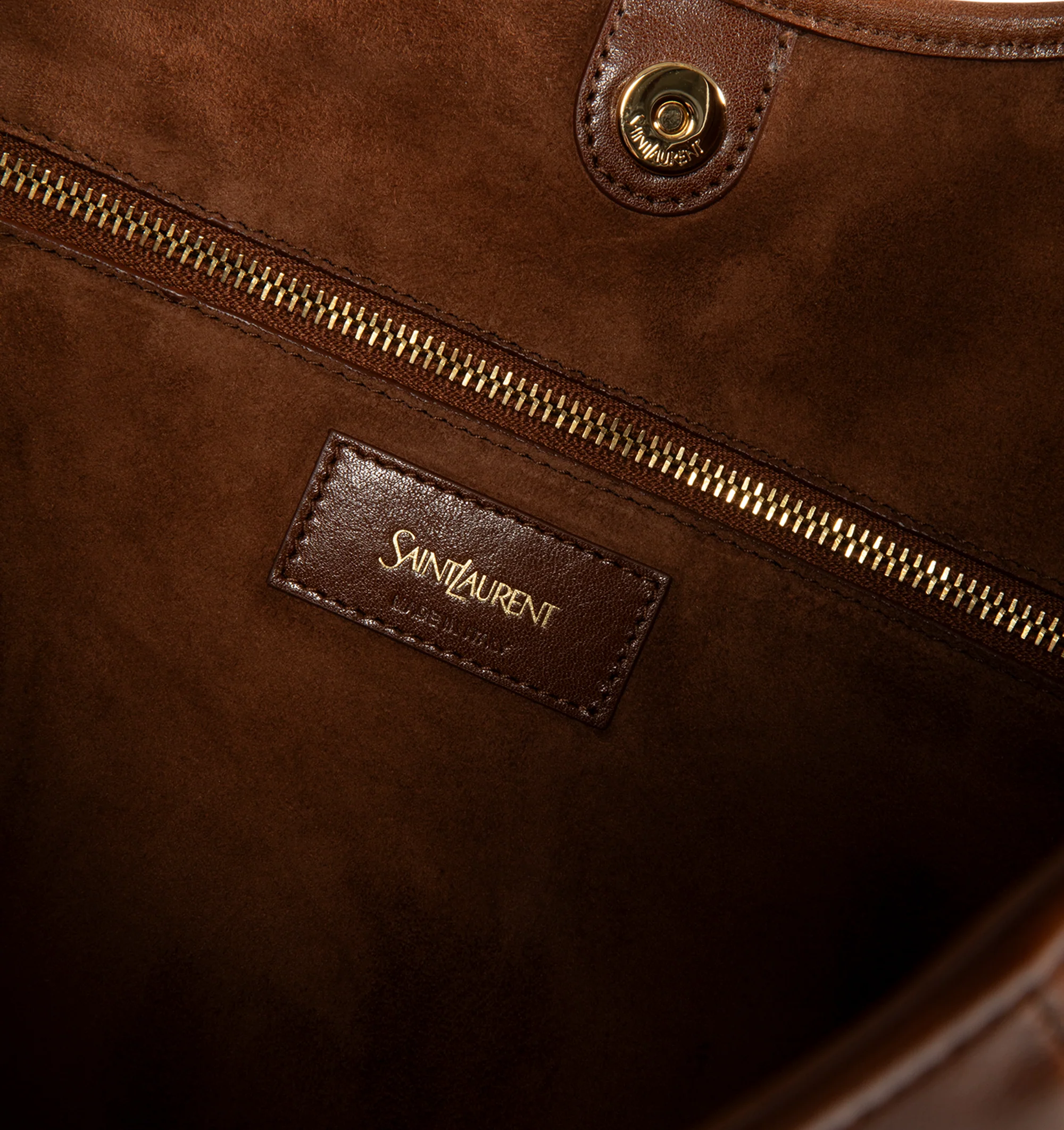 Image 3 of 3 - BROWN - Saint Laurent Women's Mombasa Medium Hobo Bag is crafted from supple calfskin leather in burnt bread brown with a tonal suede lining. Bronze-tone hardware, a leather-covered handle for hand or shoulder carry, a magnetic closure, and an interior zip pocket complete the design. Fits a large phone, slim wallet, keys, and sunglasses. Main Material: 100% Calfskin Leather. Lining: 100% Suede. Dimensions: 2440 x 2433 x 3 cm / 9.415.7 x 9.413 x 1.2 in. Handle Drop: 23 cm / 9.1 in. Made in Ita