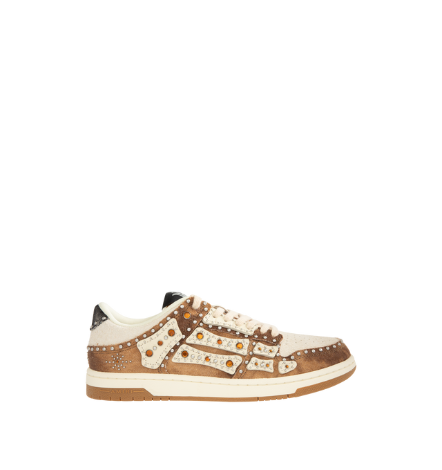 Image 1 of 5 - BROWN - AMIRI Stud Skel Top Low Sneaker featuring bone appliques, stud detailing, two-tone rubber sole with an upper paneled with washed denim and textured suede. 95% cotton, 5% polyester. Sole: rubber.
