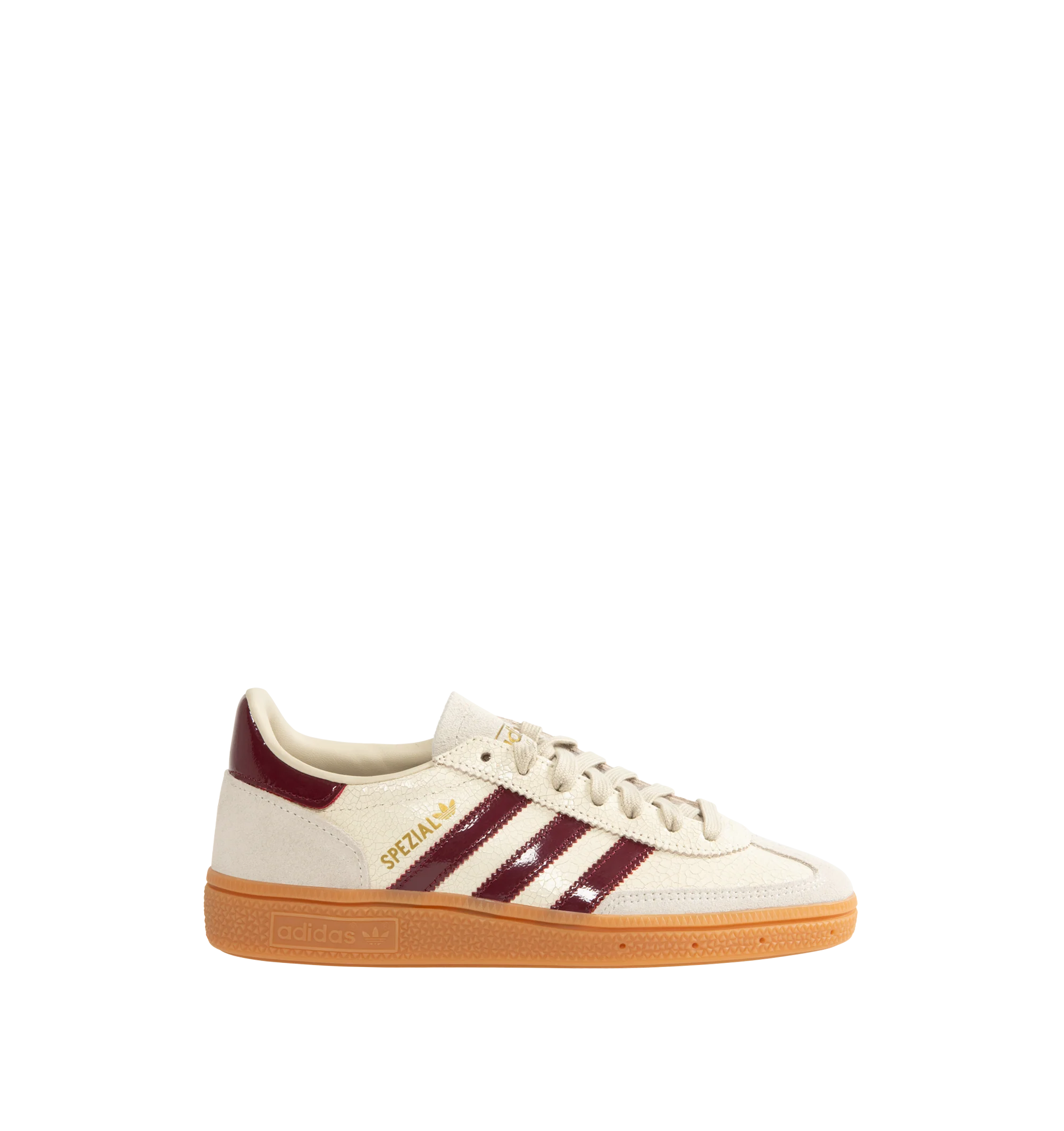 Image 1 of 5 - NEUTRAL - Adidas Men's Handball Spezial Sneakers feature a textured mix of cracked leather, suede overlays, and patent leather 3-Stripes. Designed in a regular fit with a secure lace-up closure, these designer sneakers feature signature Spezial detailing at the quarter and tongue and a soft gum rubber outsole. Upper: Leather. Lining and Insole: Textile and Other Materials. Outsole: Other Materials.