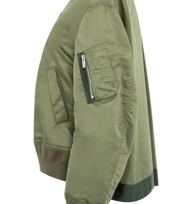 Image 3 of 3 - GREEN - SACAI Nylon Twill Blouson Bomber Jacket featuring rib-knit stand collar, hem, and cuffs, two-way zip closure, press-stud tabs at chest, welt pockets at front, press-stud vent at side seams, utility pocket at sleeve, welt pockets at interior and full satin lining. 100% nylon. Lining: 100% polyester. Made in Japan. 