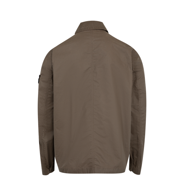 Image 2 of 4 - BROWN - STONE ISLAND Coach Jacket featuring collar with snap to wear standing, top-entry bellows hand pockets with flap and concealed snap, with overlapping angled pockets, eyelets under back armholes, Stone Island badge on left sleeve, adjustable cuffs with snap and two-way zipper fastening under snap placket. 65% polyester, 35% cotton.