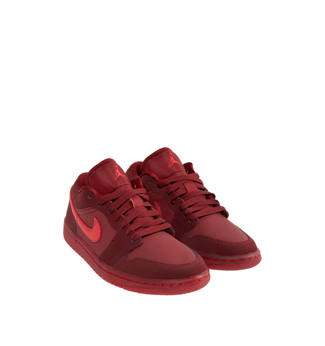 Image 2 of 5 - RED - JORDAN Air Jordan 1 Low SE Sneaker featuring leather in the upper, encapsulated Nike Air-Sole unit provides lightweight cushioning, rubber in the outsole, lace up closure, wings logo on heel and Jumpman on tongue. 