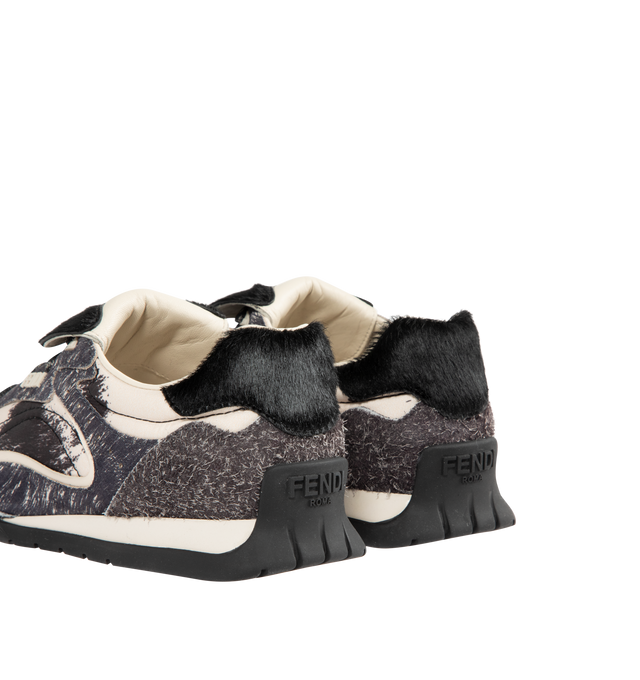 Image 3 of 5 - GREY - FENDI Wave Pulse Sneaker featuring low-top, lace-up closure, technical fabric with a gray graphic print and matching suede inserts, contrasting black cavallino calfskin details, folded tongue, tubular laces, three-dimensional rubber logo on the side, gold-colored metal Fendi logo on the tongue, rubber running sole with wraparound edge on the side and diagonal F motif. 100% calfskin. 100% polyamide. Inside: 100% lamb leather. Made in Italy.