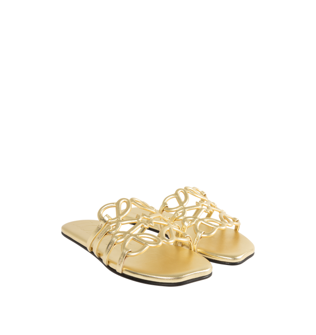 Image 2 of 4 - GOLD - LOEWE PAULA'S IBIZA Petal Anagram slide in laminated lambskin featuring a cut-out Anagram upper with hand-painted edges and hand-stitched seams, 5mm heel, embossed LOEWE on the insole, padded leather insole, rubber-injected island on the outsole and hand-stitched seams. Laminated lambskin. Made in Italy.