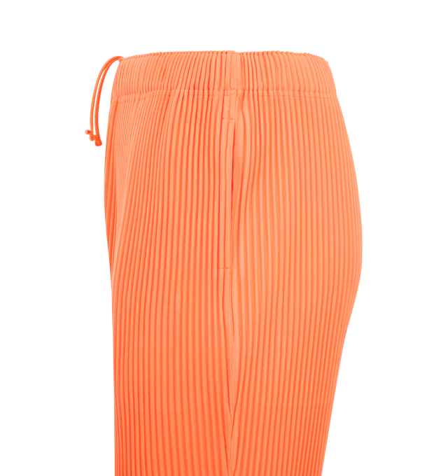 Image 3 of 3 - ORANGE - ISSEY MIYAKE Pant featuring portability and lightweight comfort, quick-drying properties, shorter length, pockets on both sides, a drawstring waist and button-fly design. 100% polyester. Made in Japan.
