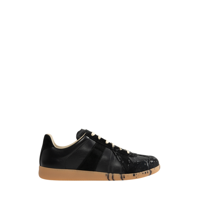 Image 1 of 5 - BLACK - MAISON MARGIELA High Quality Luxury Sneakers featuring a classic low-top silhouette, contrast of matte leather and a patent sprayed finish, paint splatter detail, lace-up construction and rubber sole. Made in Italy.